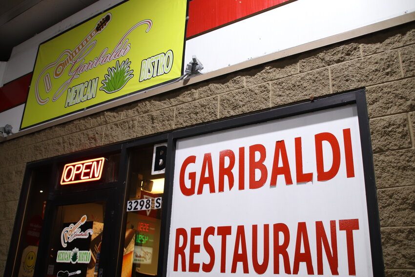 Signs mark the outside of Garibaldi Mexican Bistro on Sept. 6 in Englewood. The restaurant sits in the same building as a convenience store at a Conoco gas station, separated by a wall.